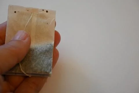 Tea Bag on White Background, Minimal Beverage Concept with Copy Space Fotos Stock