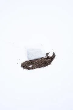A tea bag on a white background, showcasing its simplicity and clean design.. Stock Photos