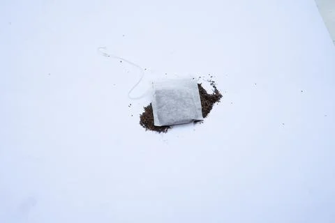 A tea bag on a white background, showcasing its simplicity and clean design.. Stock-Fotos