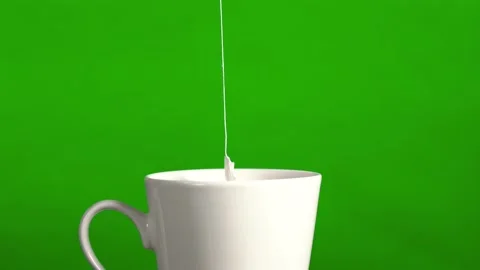 Tea bag in a white ceramic mug. Isolated on a green background. By dipping a tea Stock Footage 142746750
