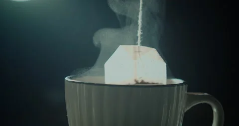 Tea bag in a white cup of tea. Making morning tea. Available in 4K and HD. This Stock Footage 170907572