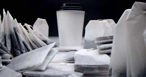 Tea bag in a white cup of tea.Super close-up set of tea bags on a white table on Stock Footage 160919879