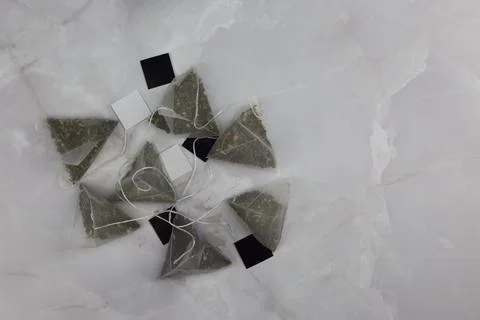 Tea bags in the shape of pyramids Stock Photos