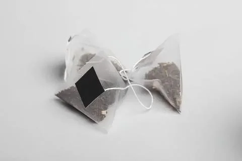Tea bags on a white surface with string and label Stock Photos