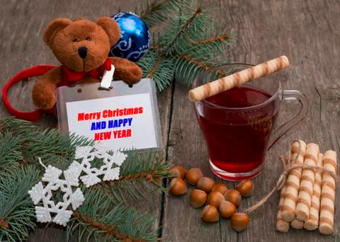 Tea, baking, nutlets and a toy bear with a label Stock Photos