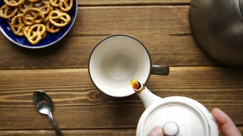 Tea being poured into cup from ceramic teapot Stock Footage 106144858