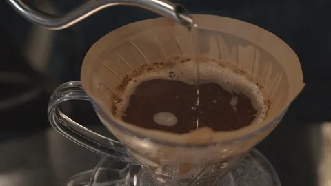 Tea being poured into filter plate from a sliver hose Video stock 103402096