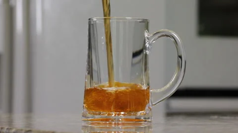Tea being poured into a glass in a kitchen  Stock Footage 61960002