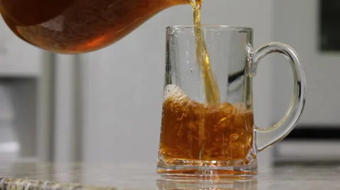 Tea being poured into a glass in a kitchen Stock Footage 61960024