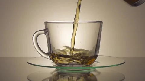 Tea being poured into glass tea cup Stock Footage 55846066