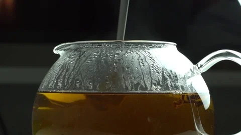 Tea being poured into glass tea Stock Footage 69780596