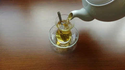 Tea being poured into glass tea cup Stock Footage 86034574