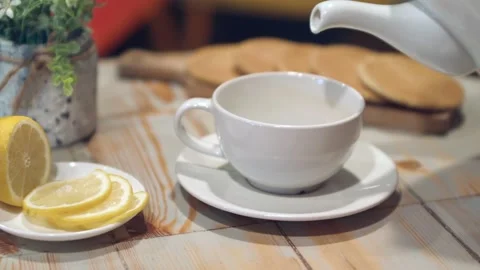 Tea being poured into white tea cup Stock Footage 137225581