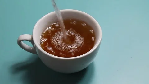 Tea being poured into white tea cup Stock Footage 150918822