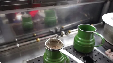 Tea being strained into green pot Stock Footage 306675747