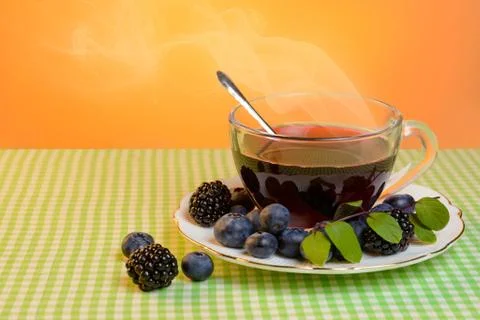 Tea with berries Stock Photos