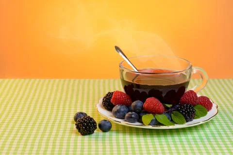 Tea with berries Stock Photos