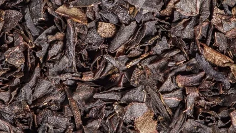 Tea black, small chopped dried leaves brown, rotating 動画素材 240645268