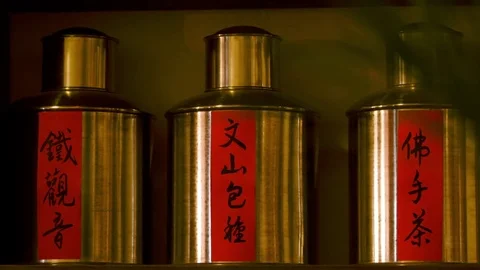 Tea bottles with Chinese calligraphy on red papers. Lunar New Year Market. Stock Footage 77267273