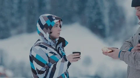 Tea break during skiing on the mountain. Man and woman drinking tea at a ski 動画素材 72372681