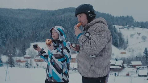 Tea break during skiing on the mountain. Man and woman drinking tea at a ski Video stock 72373553