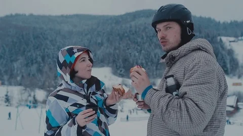 Tea break during skiing on the mountain. Man and woman drinking tea at a ski Stock Footage 72374060