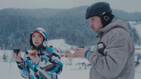 Tea break during skiing on the mountain. Man and woman drinking tea at a ski Stock Footage 72374401