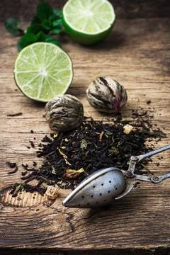 Tea brew with lime and mint on wooden background Stock Photos