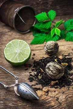 Tea brew with lime and mint on wooden background Stock Photos
