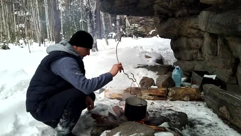 Tea is brewed over a fire in the forest Stock Footage 156187128