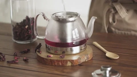 Tea brewing process. Step two. Young girl pours boiling water into a glass t 스톡 동영상 155553815