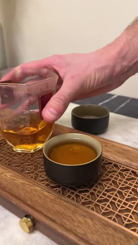 Tea brewing process, tea ceremony, a cup of freshly brewed green oolong tea Stock Footage 315220030