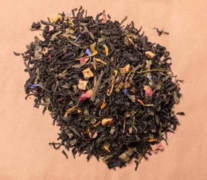 Tea in bulk on an old paper background. Enjoy your tea at work, at home, visi Stock Photos