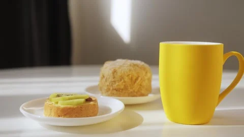 Tea with cakes on the table in kitchen. The concept of a cozy home morning over Stock Footage 247696170