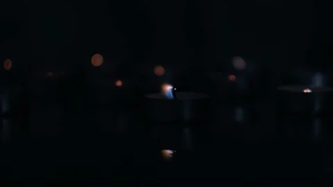 Tea Candles on Reflective Surface Burning and Fading Out Stock Footage 154659270
