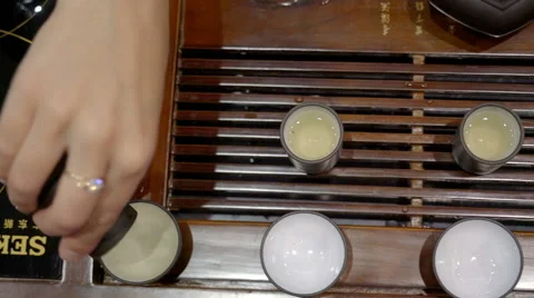 Tea Carefully Pours From the Cup Into the Bowl Stock Footage 68386653