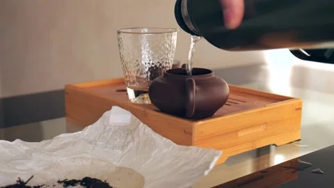 Tea ceremony, boiling water is poured into a clay teapot for brewing. Stock Footage 218448007
