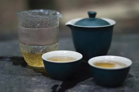 Tea ceremony in the forest. Ceramic blue teapot and tea cups Stock Photos