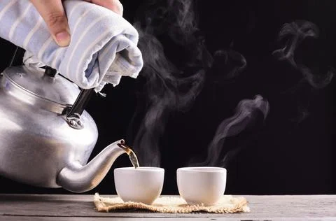 Tea ceremony process Tea ceremony A freshly brewed cup of black tea is placed Stock Photos