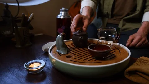 Tea ceremony. The tea master pouring hot chinese tea into the tea cup. Close up Stock Footage 116714051