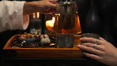 Tea ceremony. A young couple brews and pours tea. Stock Footage 162961819