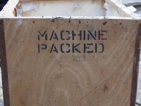Tea chest with words machine packed stencilled on wood Stock Photos
