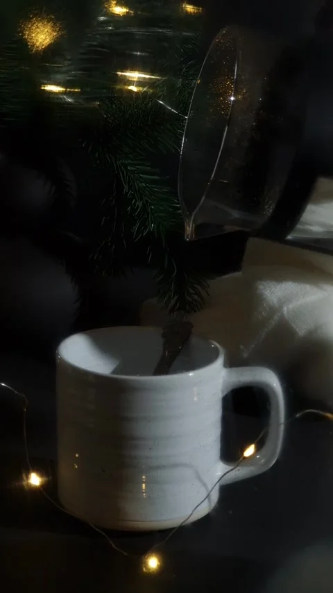 Tea with a Christmas tree and festive lights in the background. Stock Footage 300254904