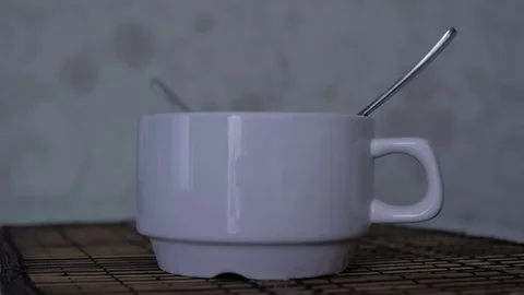 Tea, coffee, water poured into a white cup. Slow motion Video stock 77433635
