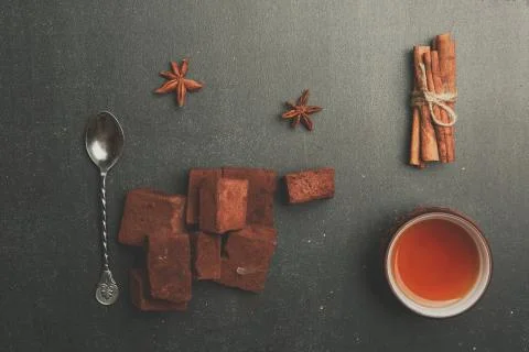 Tea composition with marshmallow, tea cup and traditional teapot on dark back Stock Photos
