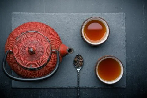 Tea composition with old spoon on dark background Stock Photos