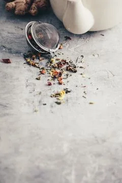 Tea composition with tea strainer with healthy herbal tea, ginger and tea pot Stock Photos