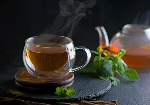 Tea concept, teapot with tea surrounded on wood background, tea ceremony, gre Stock Photos