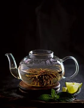 Tea concept, teapot with tea surrounded on wood background, tea ceremony, gre Stock Photos