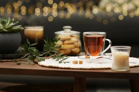Tea, cookies and decorative elements on wooden table indoors Stock Photos